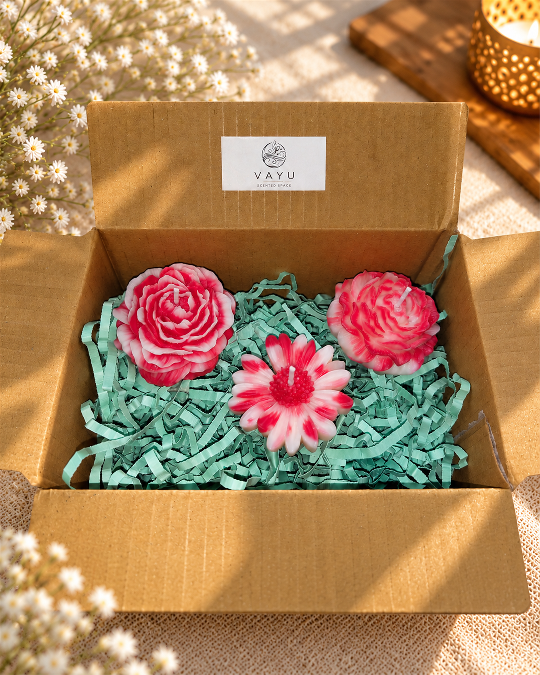 Three pink and white floral candles in a gift hamper box