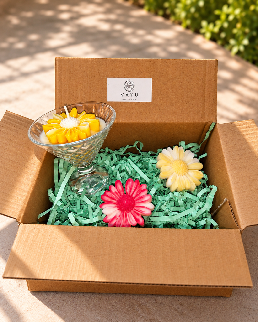 Crystal-cut dessert glass candle with a yellow flower and two freestanding daisy candles in a Vayu gift box