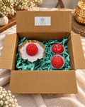 Three laddu-shaped candles with silver highlights and a pearl-trimmed display dish in a Vayu hamper box