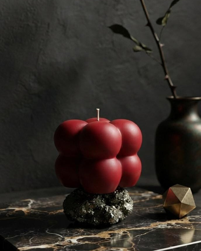 Small red Bubble candle on a marble-patterned display