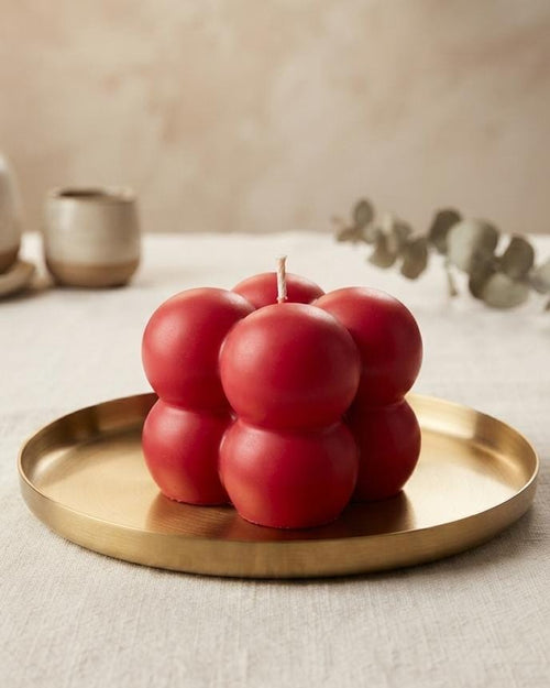 Small red Bubble candle on a brass-coloured tray
